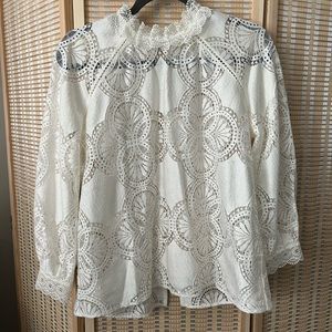 White long sleeve blouse. High collar, back slit closed by buttons